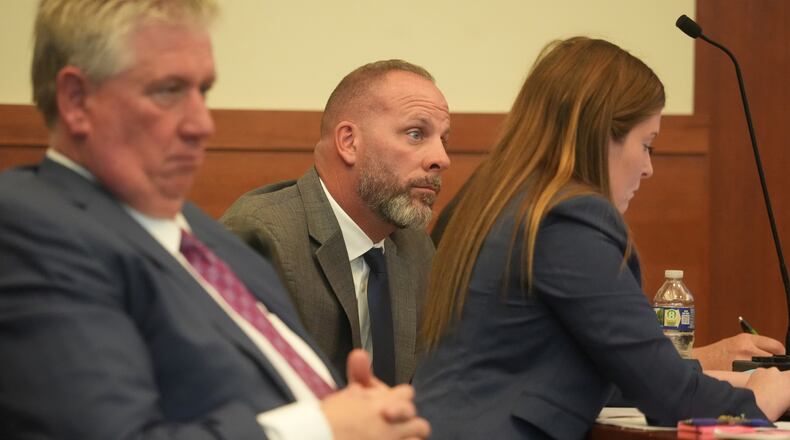 Jason Meade, center, sits with his attorneys Mark Collins, left, and Kaitlyn Stephens, right, during opening statements in the retrial of the former Ohio sheriff's deputy charged with murder and reckless homicide in the 2020 killing of Casey Goodson Jr., inside Franklin County Common Pleas Court in Columbus, Ohio, Thursday, April 23, 2026. (Doral Chenoweth/Pool photo via AP)