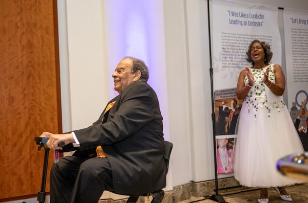 Andrew Young takes the stage, cheered on by Monica Pearson, as he is honored during the Legends of Atlanta gala at the Woodruff Arts Center on Monday. (Jenni Girtman, Amanda Brown Olmstead PR for the AJC)