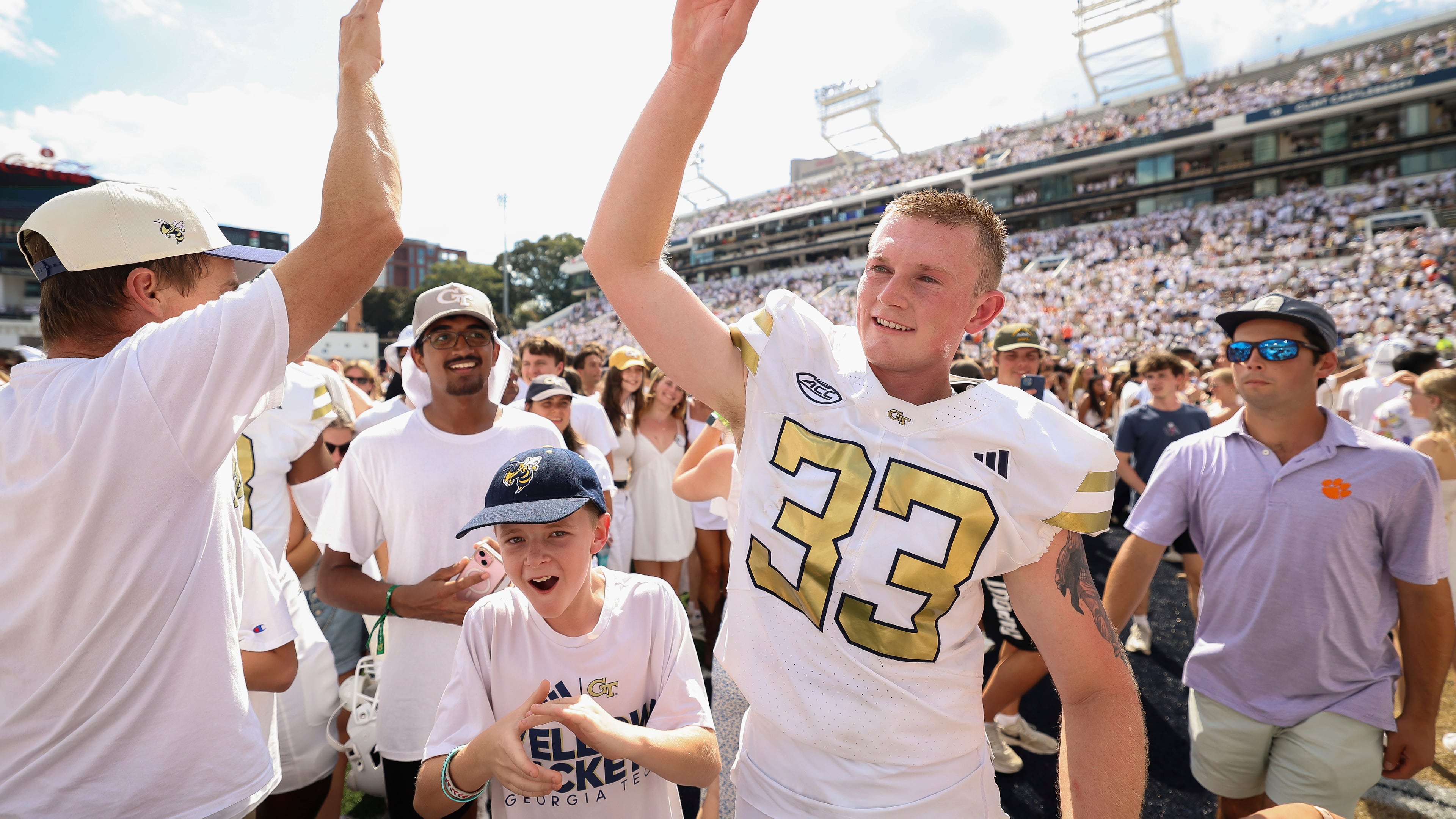 Georgia Tech place kicker Aidan Birr (33) gets ready to high-five a fan after kicking a game-winning field goal in the closing seconds of the second half of an NCAA college football game against Clemson, Saturday, Sept. 13, 2025, in Atlanta. (AP Photo/Colin Hubbard)
