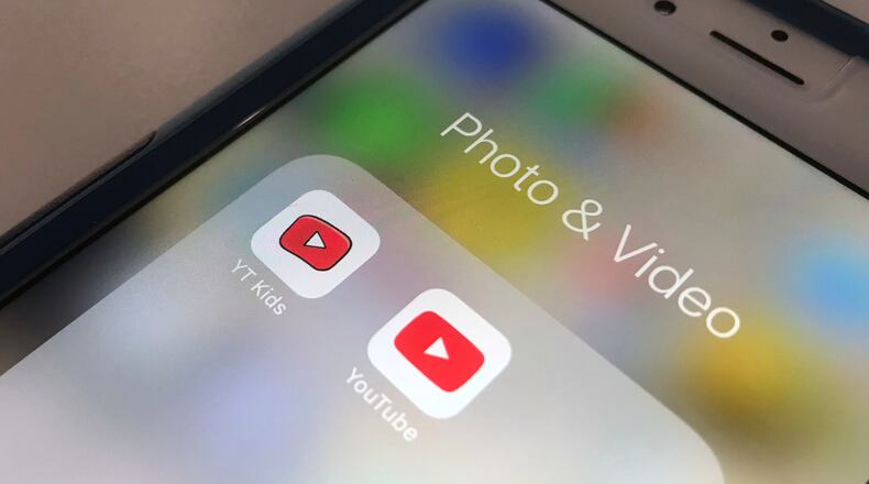 FILE - The icons for the YouTube Kids and YouTube apps are displayed on a smartphone in New York on April 25, 2018. (AP Photo/Jenny Kane, File)