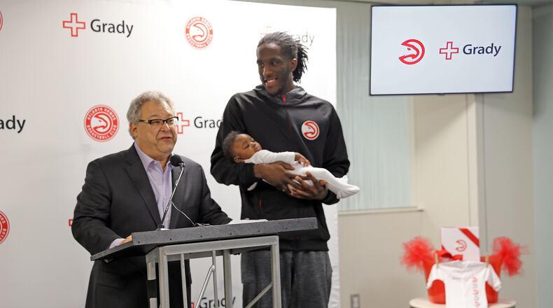 Atlanta Hawks launched a new "Hawks Baby Club" at Grady. Hawks CEO Steve Koonin and forward Taurean Prince present a newborn with the Hawks Baby Club onesie. PHOTO CREDIT: “Neda Perry/Atlanta Hawks”
