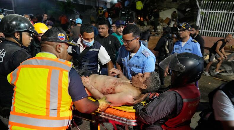 Rescue worker carry an injured man after an earthquake in Caracas, Venezuela, Wednesday, June 24, 2026. (AP Photo/Ariana Cubillos)