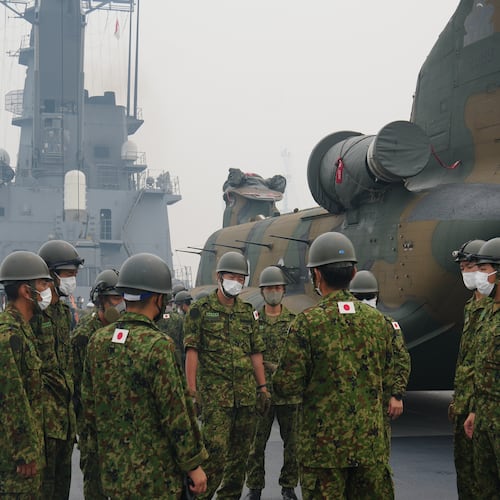 Crew members have a briefing near one of the Chinook helicopters which will be used to help battle forest fires on Kalimantan Island, on the deck of Japanese tank landing ship JS Kunisaki after its arrival at Kijing Port in Mempawah, West Kalimantan, Indonesia, Thursday, Sept. 10, 2026. (AP Photo/Tatan Syuflana)