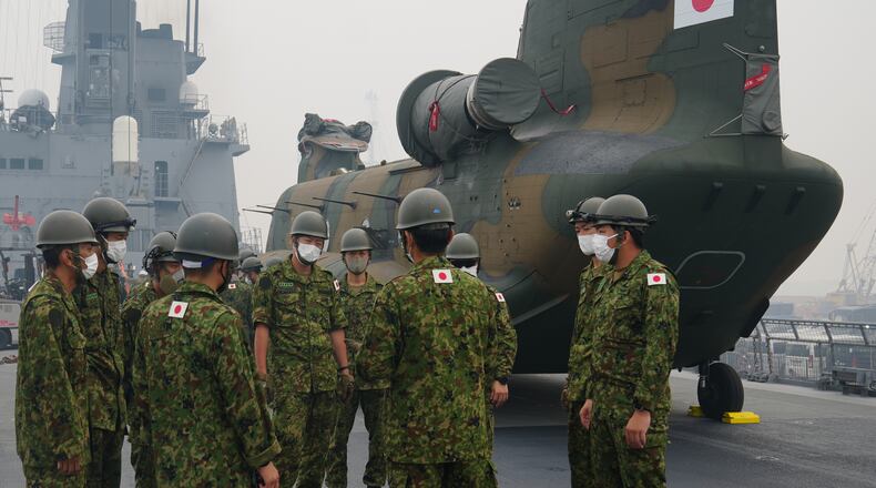 Crew members have a briefing near one of the Chinook helicopters which will be used to help battle forest fires on Kalimantan Island, on the deck of Japanese tank landing ship JS Kunisaki after its arrival at Kijing Port in Mempawah, West Kalimantan, Indonesia, Thursday, Sept. 10, 2026. (AP Photo/Tatan Syuflana)