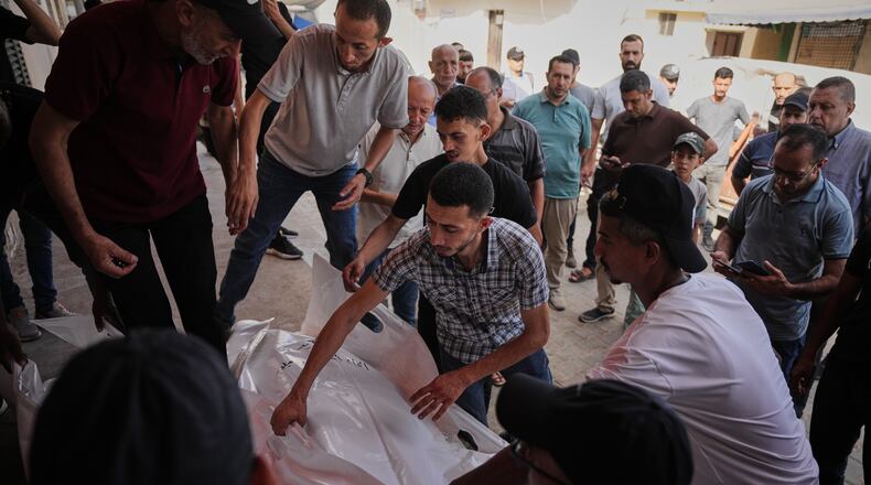 Mourners carry the bodies of Kamal Abu Muailiq, 68, and his wife, Huda Abu Muailiq, 59, who were killed in an Israeli airstrike, during their funeral in Deir al-Balah, Gaza Strip, Sunday, Aug. 2, 2026. (AP Photo/Abdel Kareem Hana)