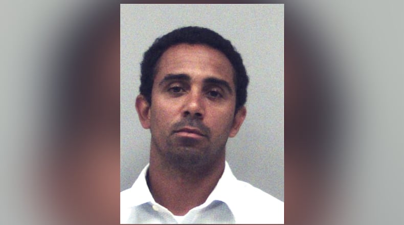 Former UGA wide receiver and Gwinnett County teacher "Mikey” Henderson was arrested May 19 on one charge of sexual assault.