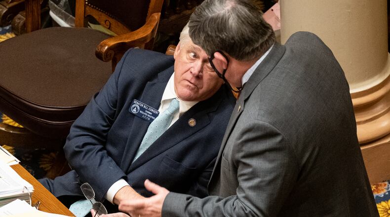 Republican state Sen. Bill Cowsert of Athens, seated, speaks with Republican state Sen. Larry Walker III of Perry during debate Monday on a bill to overhaul Georgia's citizen's arrest law. Ben Gray for the Atlanta Journal-Constitution