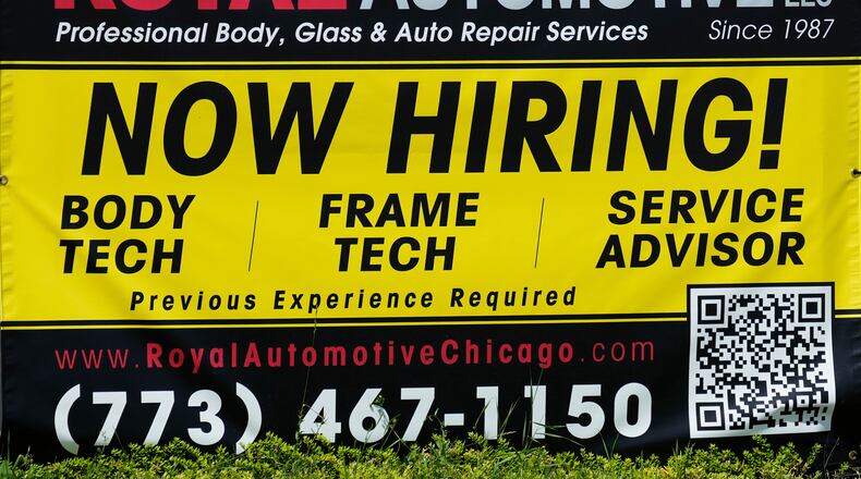 FILE - A now hiring sign is seen in front of an auto body shop in Chicago, June 25, 2026. (AP Photo/Nam Y. Huh, file)