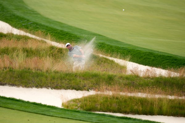Scottie Scheffler plays out of the Church Pews bunker on the third hole during the second round of the U.S. Open golf tournament at Oakmont Country Club Friday, June 13, 2025, in Oakmont, Pa. (AP Photo/Charlie Riedel)