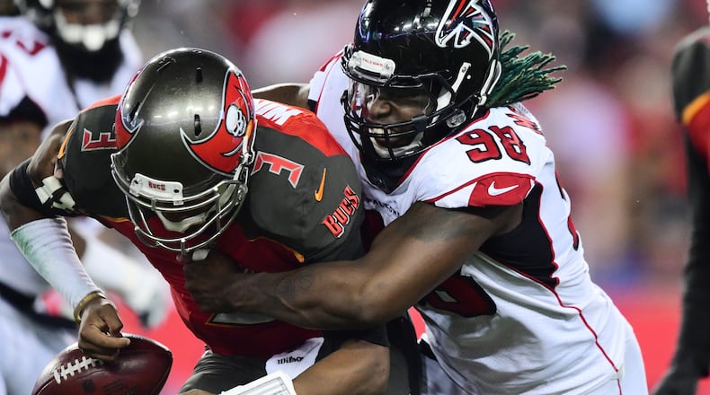 Falcons defensive end Takkarist McKinley wraps up Buccaneers quarterback Jameis Winston to cause a fumble in the second quarter Dec. 18, 2017 at Raymond James Stadium in Tampa.