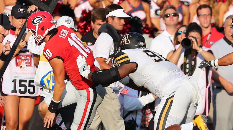 Georgia quarterback Jacob Eason (10) is injured and leaves the game as he is pushed out of bounds by Appalachian State defender Myquon Stout, who was penalized on the play, during the first quarter on Saturday, Sept. 2, 2017, at Sanford Stadium in Athens, Ga. (Curtis Compton/Atlanta Journal-Constitution/TNS)