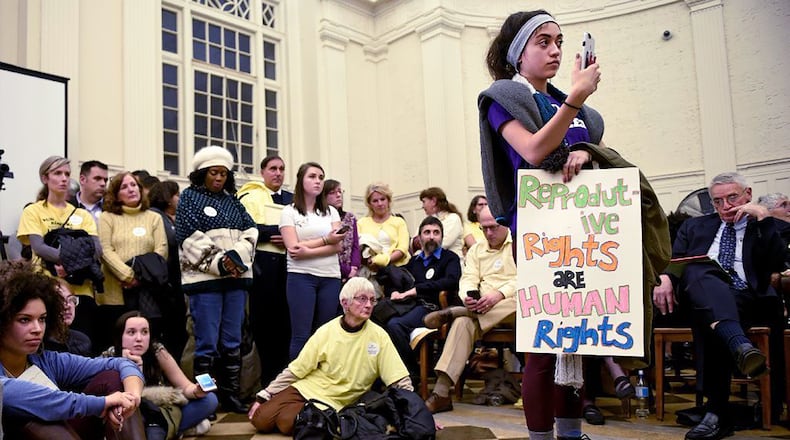 In this 2017 photo, Gragiela Valencia, a then-sophomore at Trinity College, was one of many students that attended a crowded council meeting at city hall as Hartford sought to crack down on faith-driven crisis pregnancy centers, which critics say sometimes pose as clinics to lure women and hand out misleading information about abortions. In 2022, $2 million in public funds was allocated to the 89 crisis pregnancy centers in Georgia. (John Woike/Hartford Courant/TNS)