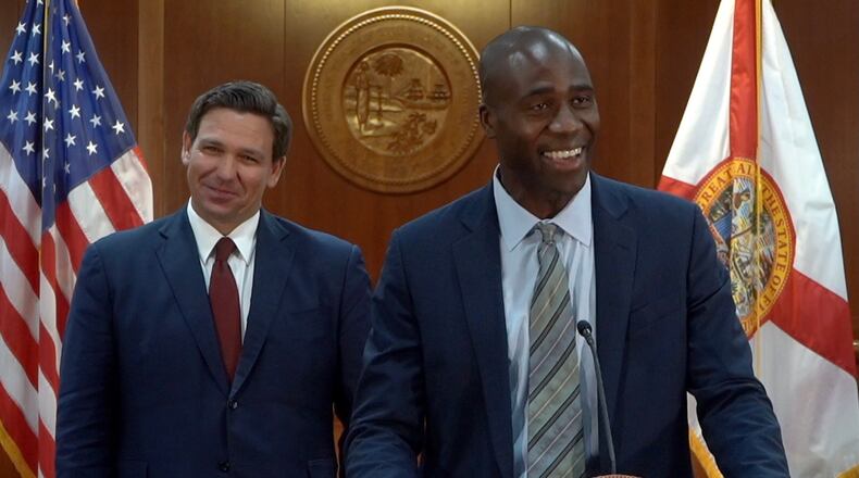 Florida Surgeon General Joseph Ladapo, right, on Tuesday wrote on Twitter about his refusal to wear a mask while meeting with state Sen. Tina Polsky, who has breast cancer, saying he can’t “communicate clearly and effectively” with his face covered. (Governor's Office photo/TNS)