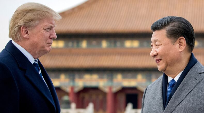 FILE - President Donald Trump, left, and Chinese President Xi Jinping tour the Forbidden City, Nov. 8, 2017, in Beijing, China. (AP Photo/Andrew Harnik, File)