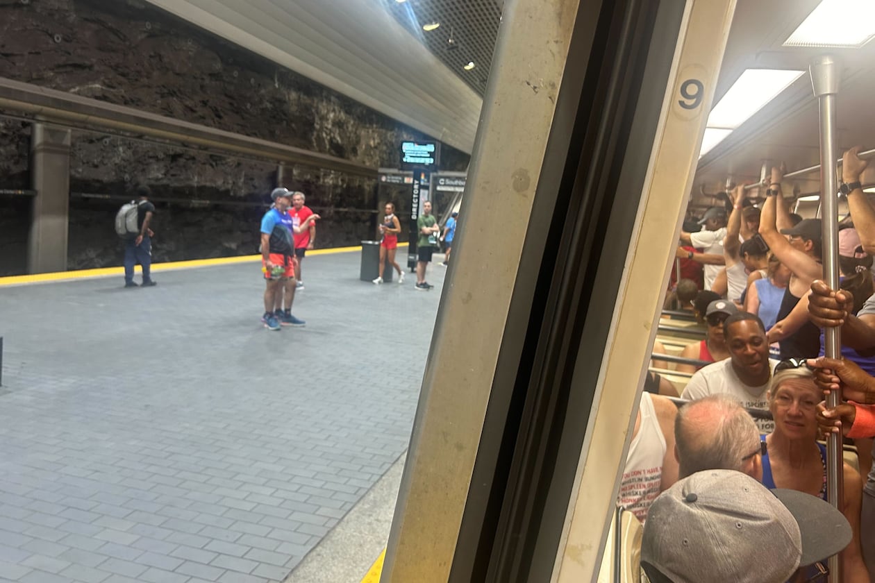 Runners headed to the Peachtree Road Race stand shoulder-to-shoulder on a northbound train leaving Peachtree Center Station around 6:30 a.m. Friday. (Gray Mollenkamp/AJC)