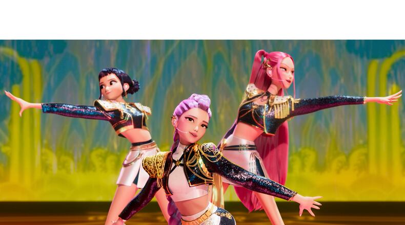 This image released by Netflix shows characters Zoey, from left, Rumi and Mira in a scene from "KPop Demon Hunters." (Netflix via AP)
