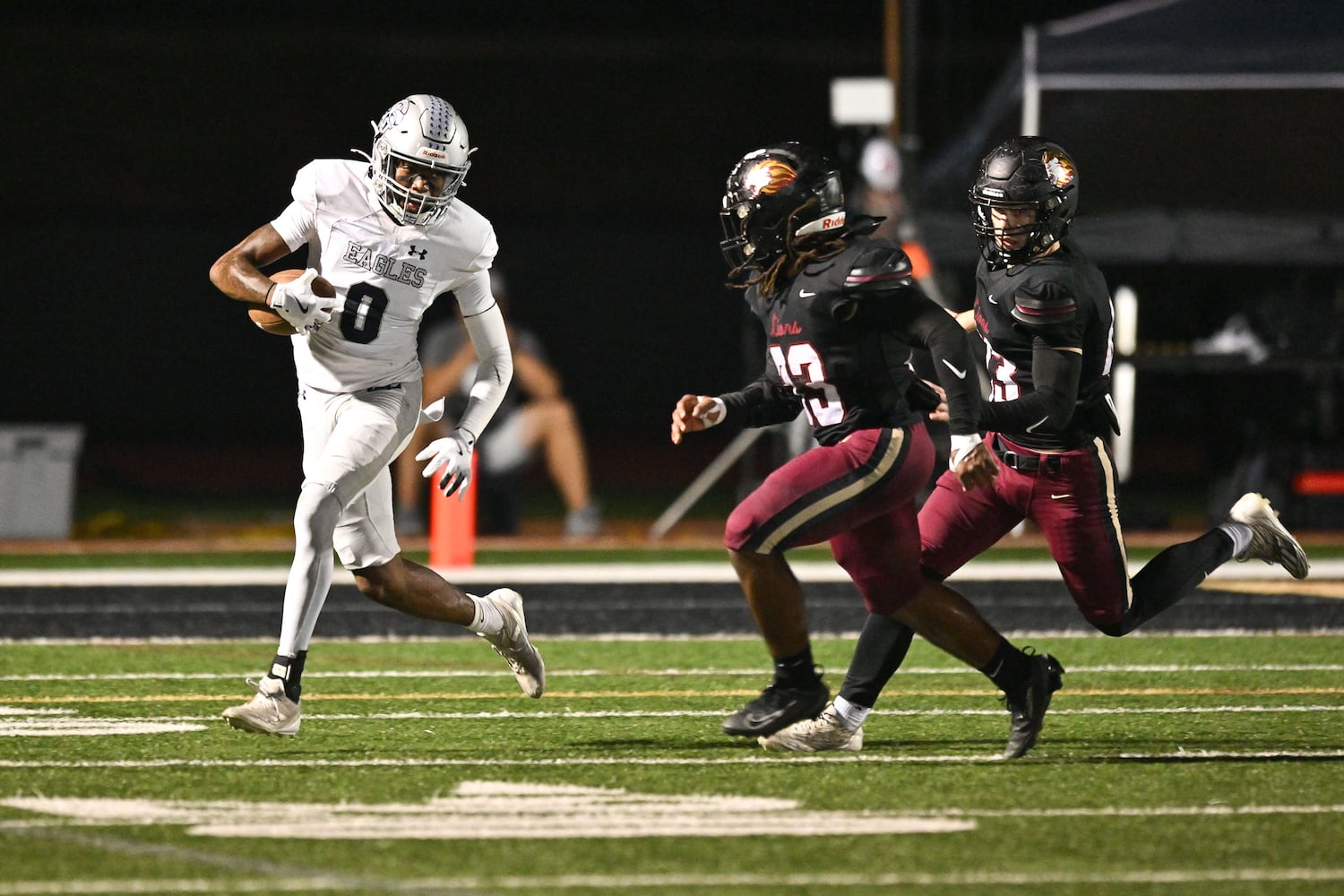 East Jackson wide receiver Branturan Callahan (left) maneuvers the ball against Hebron’s defense during the first half of play Friday, Sept. 26, 2025, at Hebron Christian Academy. (Daniel Varnado for the AJC)
