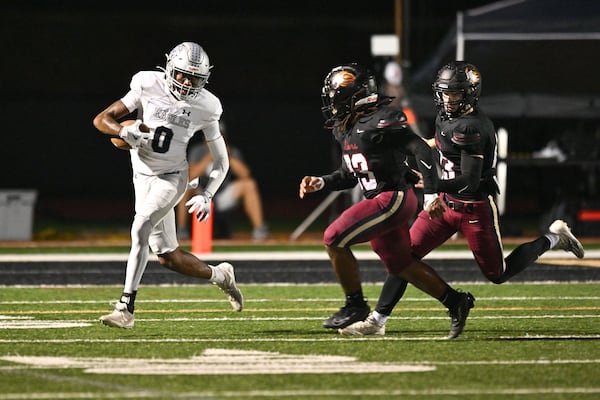 East Jackson wide receiver Branturan Callahan maneuvers the ball against Heabron’s defense during the first half of play Friday, Sept. 26, 2025, at Hebron Christian Academy. (Daniel Varnado for the AJC)