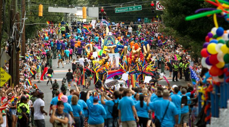 Spectators pack 10th street as the Atlanta Pride Parade heads toward Piedmont Park Sunday, Oct. 15, 2017.
