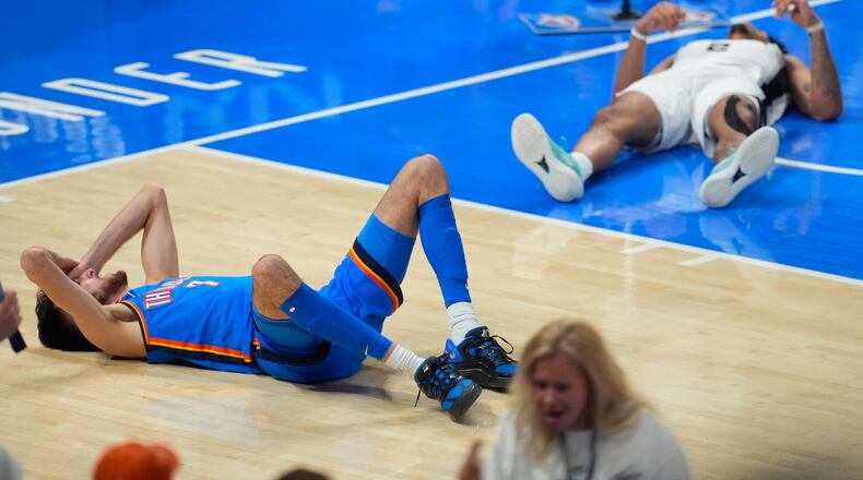 Oklahoma City Thunder center Chet Holmgren (7) and San Antonio Spurs guard Dylan Harper (2) react after a foul call during the second half of Game 2 in the Western Conference finals NBA basketball playoffs series Wednesday, May 20, 2026, in Oklahoma City. (AP Photo/Tony Gutierrez)