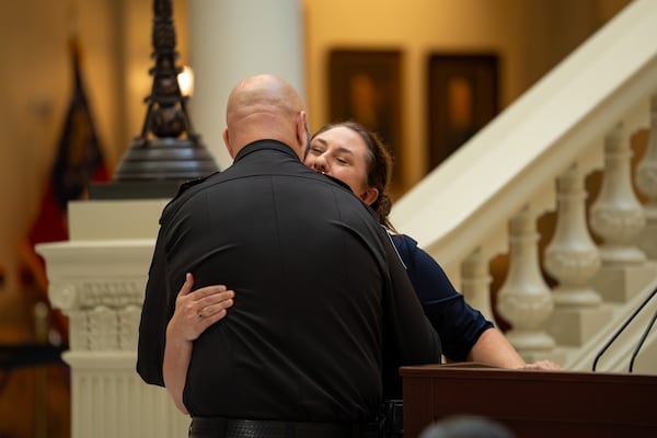 Apalachee High School principal Jessica Rehberg hugs Barrow County Sheriff Jud Smith at a ceremony at the Capitol declaring Sept. 4 as Apalachee Remembrance Day. (Ben Hendren for the AJC)