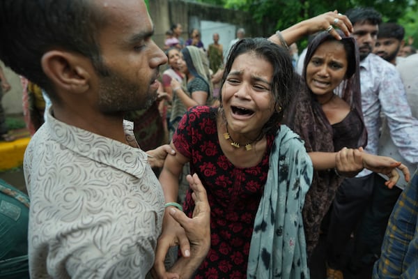 Family members and relatives of Akash Patni, victim of the Air India plane crash, grieve during his funeral procession in Ahmedabad, India, Tuesday, June 17, 2025. (AP Photo/Ajit Solanki)