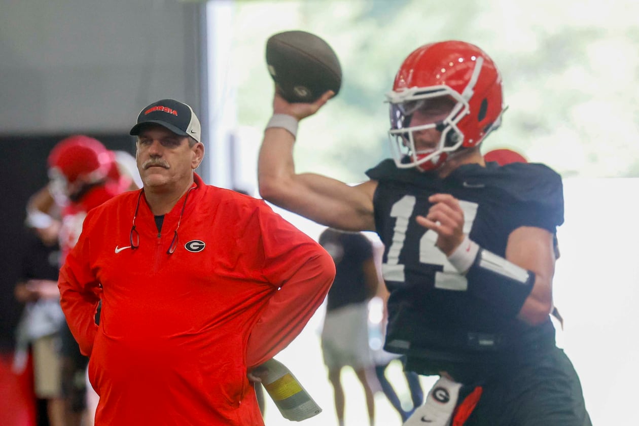 Georgia offensive coordinator Mike Bobo watches quarterback Gunner Stockton (14) throw a pass during their first football practice at the University of Georgia practice facility, Wednesday, August 5, 2026, in Athens, Ga. (Miguel Martinez/AJC)