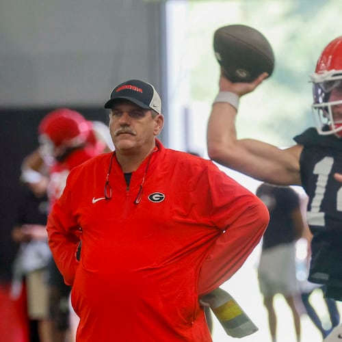 Georgia offensive coordinator Mike Bobo watches quarterback Gunner Stockton (14) throw a pass during their first football practice at the University of Georgia practice facility, Wednesday, August 5, 2026, in Athens, Ga. (Miguel Martinez/AJC)