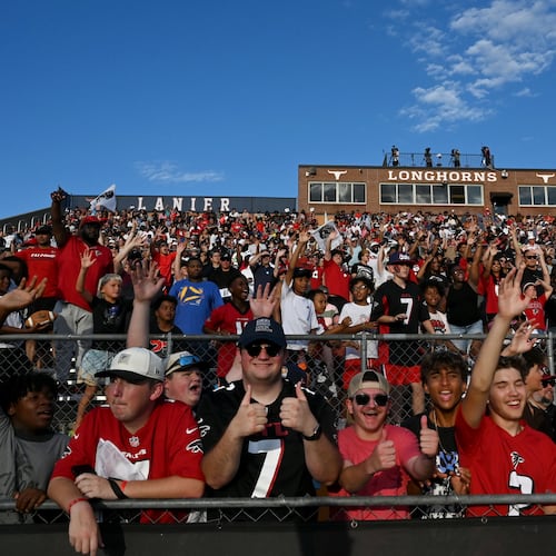 Football fans cheer as they watch the Falcons' "Saturday Night Lights" practice at Lanier High School on Saturday, Aug. 8, 2026, in Sugar Hill. (Hyosub Shin/AJC)