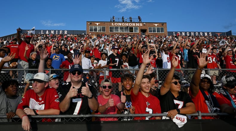 Football fans cheer as they watch the Falcons' "Saturday Night Lights" practice at Lanier High School on Saturday, Aug. 8, 2026, in Sugar Hill. (Hyosub Shin/AJC)