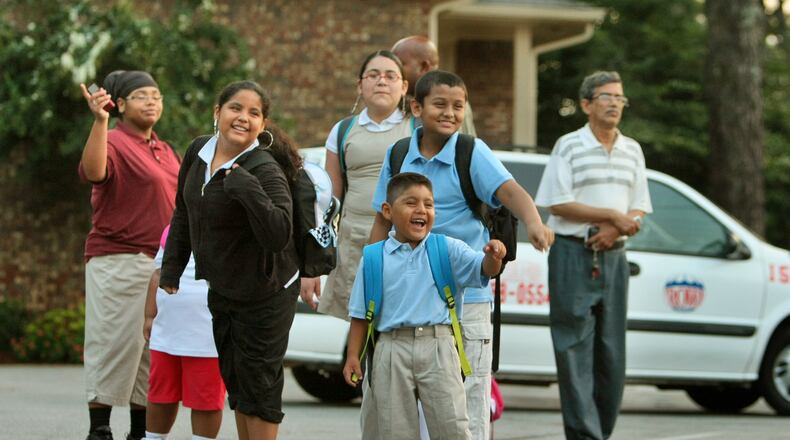 DeKalb County school children gathered at the Gardens Apartments on Buford Highway for the first day of school in 2010. John Spink/jspink@ajc.com