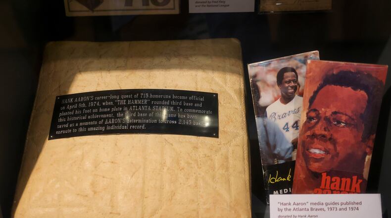 This is third base that Hank Aaron stepped on after he hit home run No. 715 on April 8, 1974, at Atlanta Stadium, shown in the exhibit, "Hank Aaron: Chasing The Dream," at the National Baseball Hall of Fame, May 23, 2024, in Cooperstown, New York. Also pictured are media guides from the Atlanta Braves from 1973 and 1974. (Jason Getz/The Atlanta Journal-Constitution/TNS)