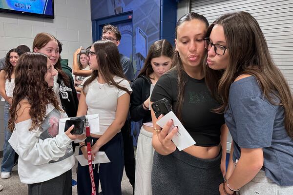 Twin sisters Emma Leibowitz, left, and Kayla Leibowitz attend rehearsal for Plainview-Old Bethpage John F. Kennedy High School's graduation ceremony at Hofstra University in Hempstead, N.Y., on Tuesday, June 17, 2025. (AP Photo/Philip Marcelo)