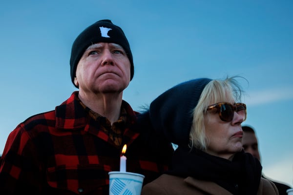 Minnesota Gov. Tim Walz and first lady Gwen Walz, attend a vigil honoring Renee Good on Friday, Jan. 9, 2026, in St. Paul, Minn., outside the Minnesota State Capitol. (Kerem Yücel/Minnesota Public Radio via AP)