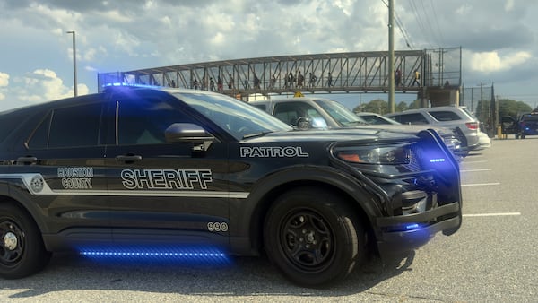 Students leave Warner Robins High School as Houston County Sheriff vehicles remain on the scene after a shooting on campus left one injured at the Middle Georgia school on August 12, 2026, officials said. Police have a suspect in custody. (Joe Kovac/AJC)