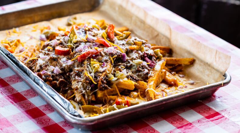 The Greater Good BBQ’s chili cheese fries are topped with house-made smoked jalapeno queso. CONTRIBUTED BY HENRI HOLLIS