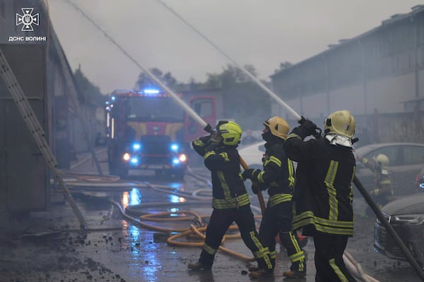 In this photo provided by the Ukrainian Emergency Service, firefighters put out the fire following a Russian attack in Volyn region, Ukraine, Wednesday, July 9, 2025. (Ukrainian Emergency Service via AP)