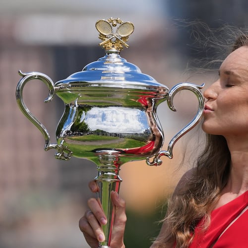 Elena Rybakina of Kazakhstan poses with Daphne Akhurst Memorial Cup on the banks of the Yarra River the morning after defeating Aryna Sabalenka of Belarus in the women's singles final at the Australian Open tennis championship in Melbourne, Australia, Sunday, Feb. 1, 2026. (AP Photo/Dita Alangkara)