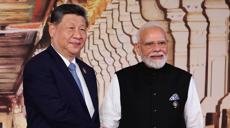 Chinese President Xi Jinping, left, and Indian Prime Minister Narendra Modi pose for a photo during an official welcome ceremony of the BRICS Summit in New Delhi, India, on Saturday, Sept. 12, 2026. (Alexander Kazakov, Sputnik, Kremlin Pool Photo via AP)