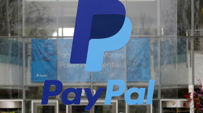 FILE - The PayPal logo hangs displayed outside their company headquarters, March 10, 2015, in San Jose, Calif. (AP Photo/Jeff Chiu, File)