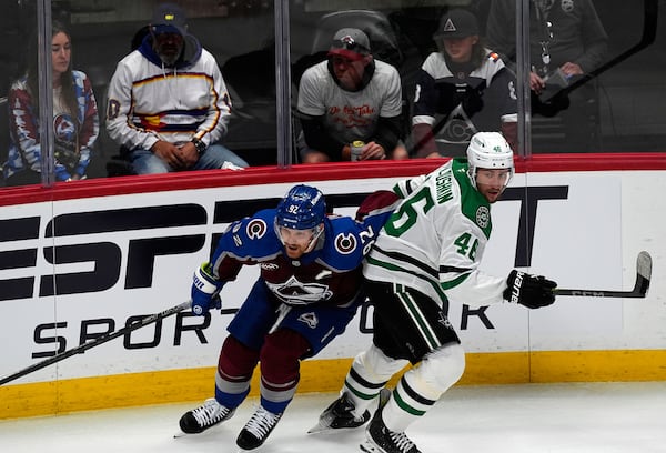 Colorado Avalanche left wing Gabriel Landeskog, left, pursues the puck with Dallas Stars defenseman Ilya Lyubushkin in the first period of Game 3 of an NHL hockey first-round playoff series Wednesday, April 23, 2025, in Denver. (AP Photo/David Zalubowski)