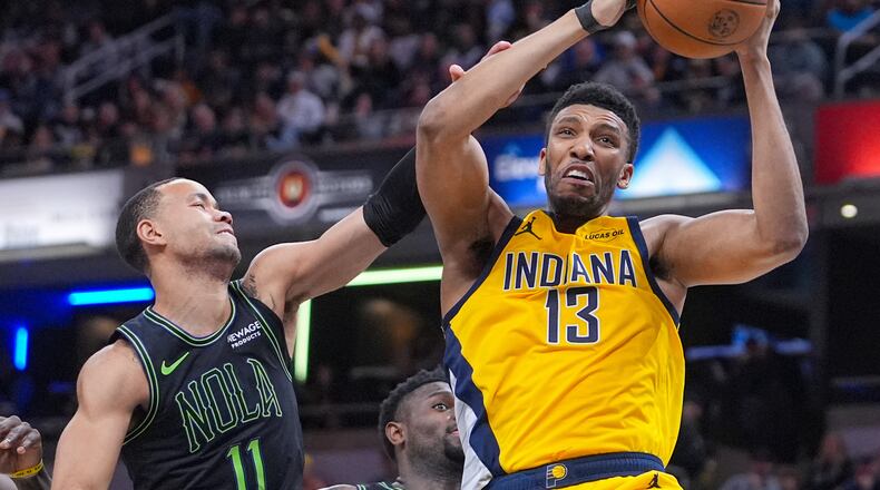 FILE - Indiana Pacers center Tony Bradley (13) is fouled as he rebounds over New Orleans Pelicans guard Bryce McGowens (11) during the second half of an NBA basketball game in Indianapolis, Friday, Jan. 16, 2026. (AP Photo/Michael Conroy, File)