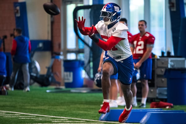 New York Giants linebacker Abdul Carter (51) catches a football during the NFL football team's rookie minicamp, Friday, May 9, 2025, in East Rutherford, N.J. (AP Photo/Angelina Katsanis)