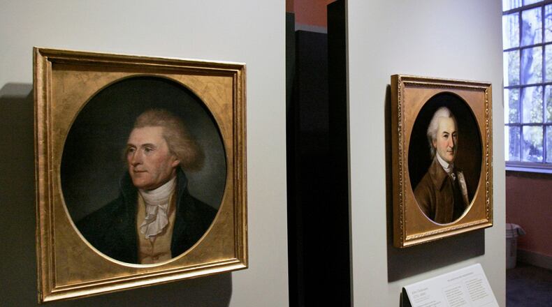 FILE - Portraits of a red-headed Thomas Jefferson, left, and John Dickinson, right, by by Charles Willson Peale are seen at the refurbished Second Bank of the United States in Philadelphia on Nov. 26, 2004. (AP Photo/Jacqueline Larma, File)