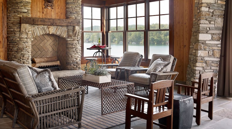 Wood, stone and a view of water and trees outside allow this indoor space from Carter Kay Interiors to embrace the outdoors. Courtesy of Carter Kay Interiors