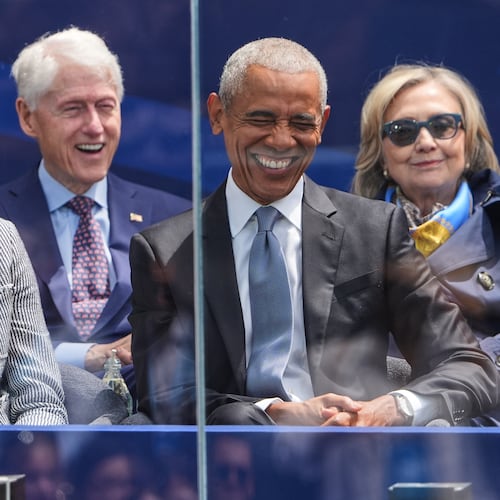 Former President Barack Obama, right, shares a laugh with former first lady Michelle Obama, left, on stage during the dedication ceremony for the Obama Presidential Center, Thursday, June 18, 2026, in Chicago. (AP Photo/Jeff Roberson)