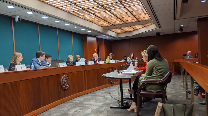 Hannah Heck (foreground) listens as Sen. Renee Unterman, R-Buford, presents her legislation, Senate Bill 386, expanding Georgia’s special needs scholarship program, during a Feb. 26, 2020 hearing of the Senate Education and Youth Committee. Heck, a lobbyist with the American Federation for Children, which supports public funding for private schools, said she herself is a mother of children with special needs.