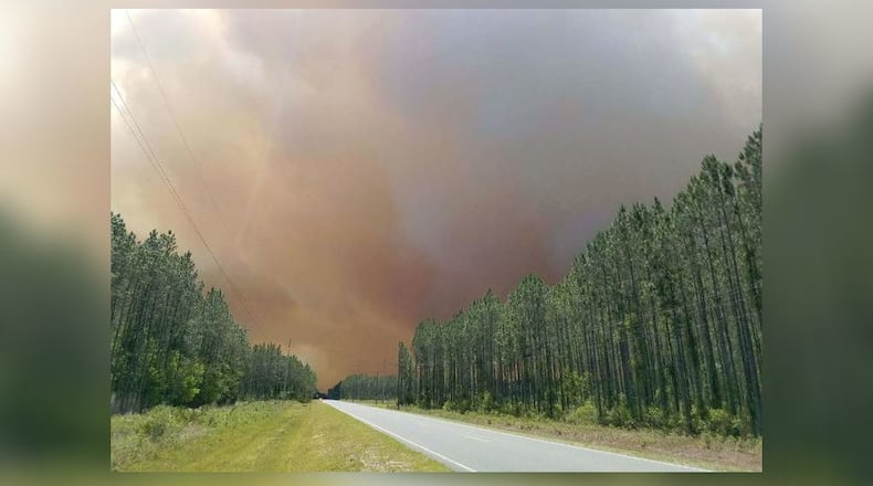 Smoke from the West Mims Fire is visible above this road in Charlton County, Ga. (Credit: Okefenokee National Wildlife Refuge)