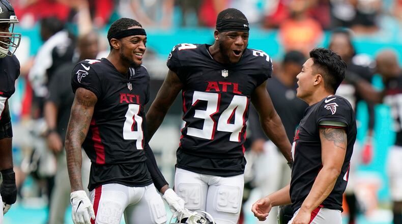 Falcons wide receiver Tajae Sharpe (4) and cornerback Darren Hall (34) congratulate kicker Younghoe Koo (7) after he kicked the game-winning field goal in the closing seconds against the Miami Dolphins, Sunday, Oct. 24, 2021, in Miami Gardens, Fla. The Falcons won 30-28. (Wilfredo Lee/AP)