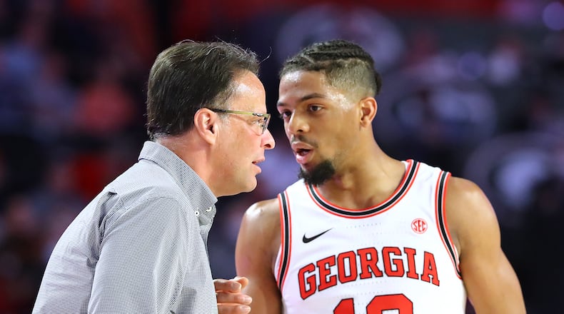 Georgia coach Tom Crean confers with Aaron Cook during a game against Auburn. (Curtis Compton / Curtis.Compton@ajc.com)